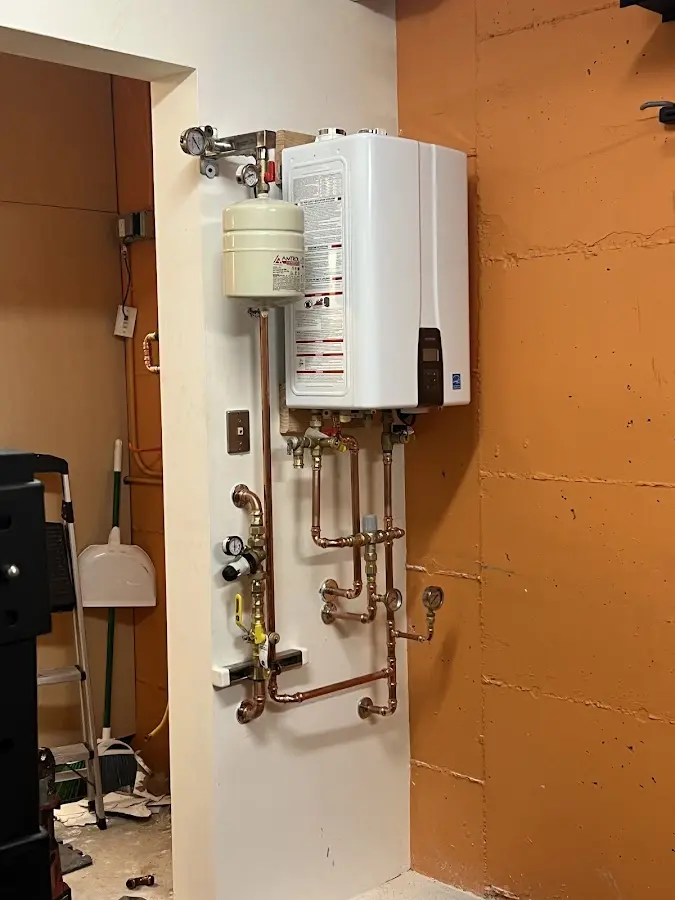 Plumbing technician inspecting water heater connections in Sierra Madre